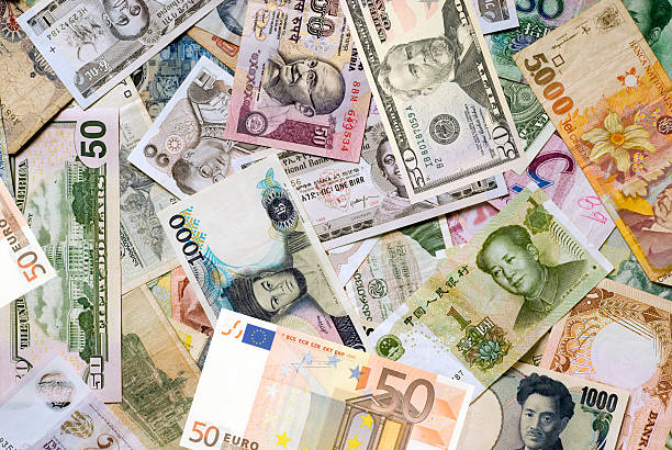 Mosaic collection of currencies from around the world. In the full frame image one can find among others Indian rupee, Chinese yuan, Japanese yen, US dollar, Thai baht, Singapore dollar, Brazilian real, European euro and Mexican peso. The paper money is mixed and the image is full frame.