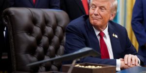 U.S. President Donald Trump sits the Oval Office to sign an executive order on AI and pediatric cancer research, at the White House, Washington, D.C., U.S., September 30, 2025. REUTERS/Nathan Howard